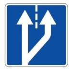 513 Eismo juostos pradžia iš dešinės (Papildoma eismo juosta arba lėtėjimo juostos pradžia. Iš kelio išsukančios transporto priemonės turi persirikiuoti į lėtėjimo juostą, į kalną važiuojančios transporto priemonės, kurios negali važiuoti greičiau už važiuojančias paskui jas, turi persirikiuoti į papildomą eismo juostą)